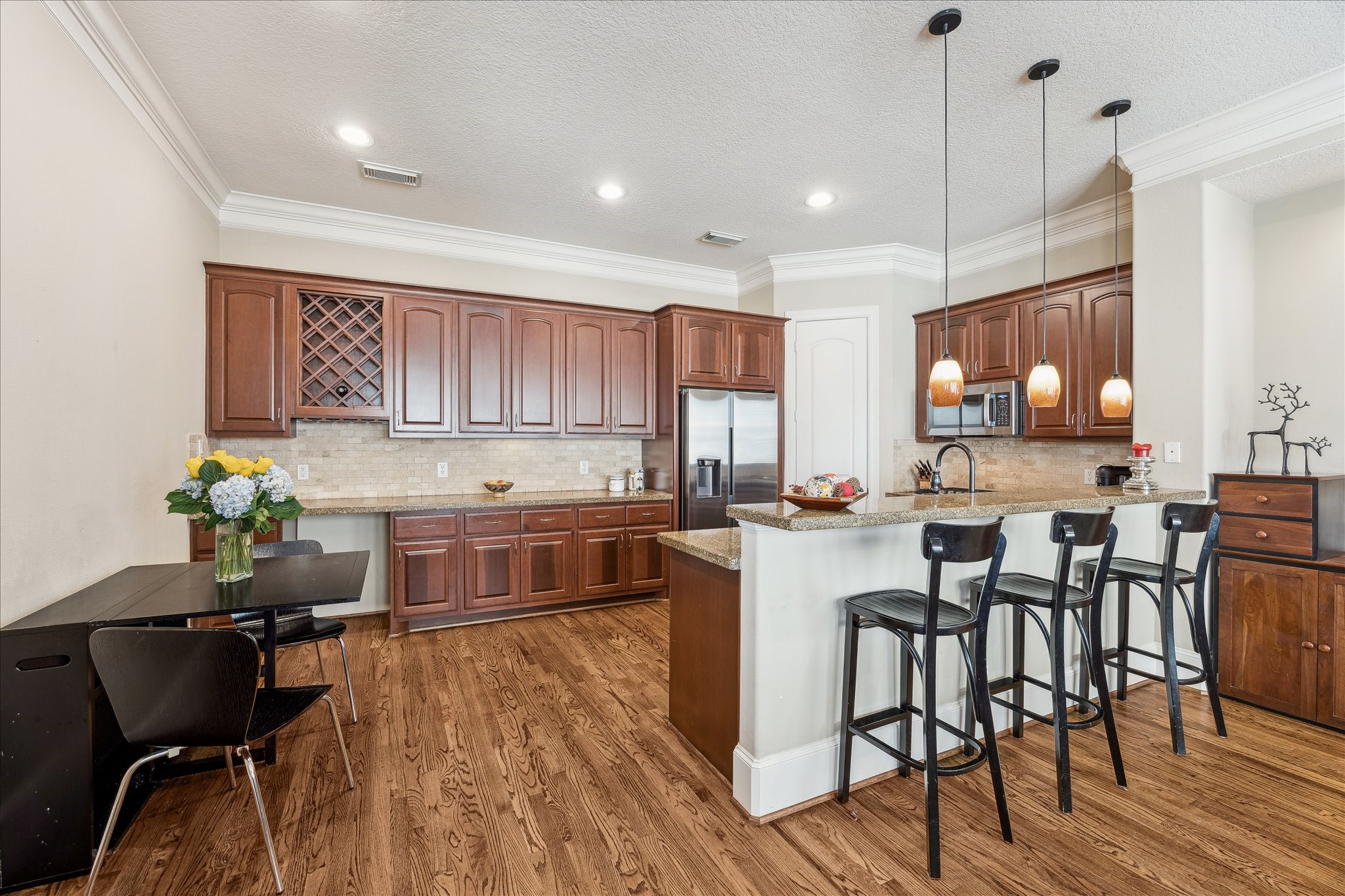 6311 Hamman Street, Unit A Houston, TX 77007 - Photo 12 of 30 a kitchen with a table chairs stove and cabinets