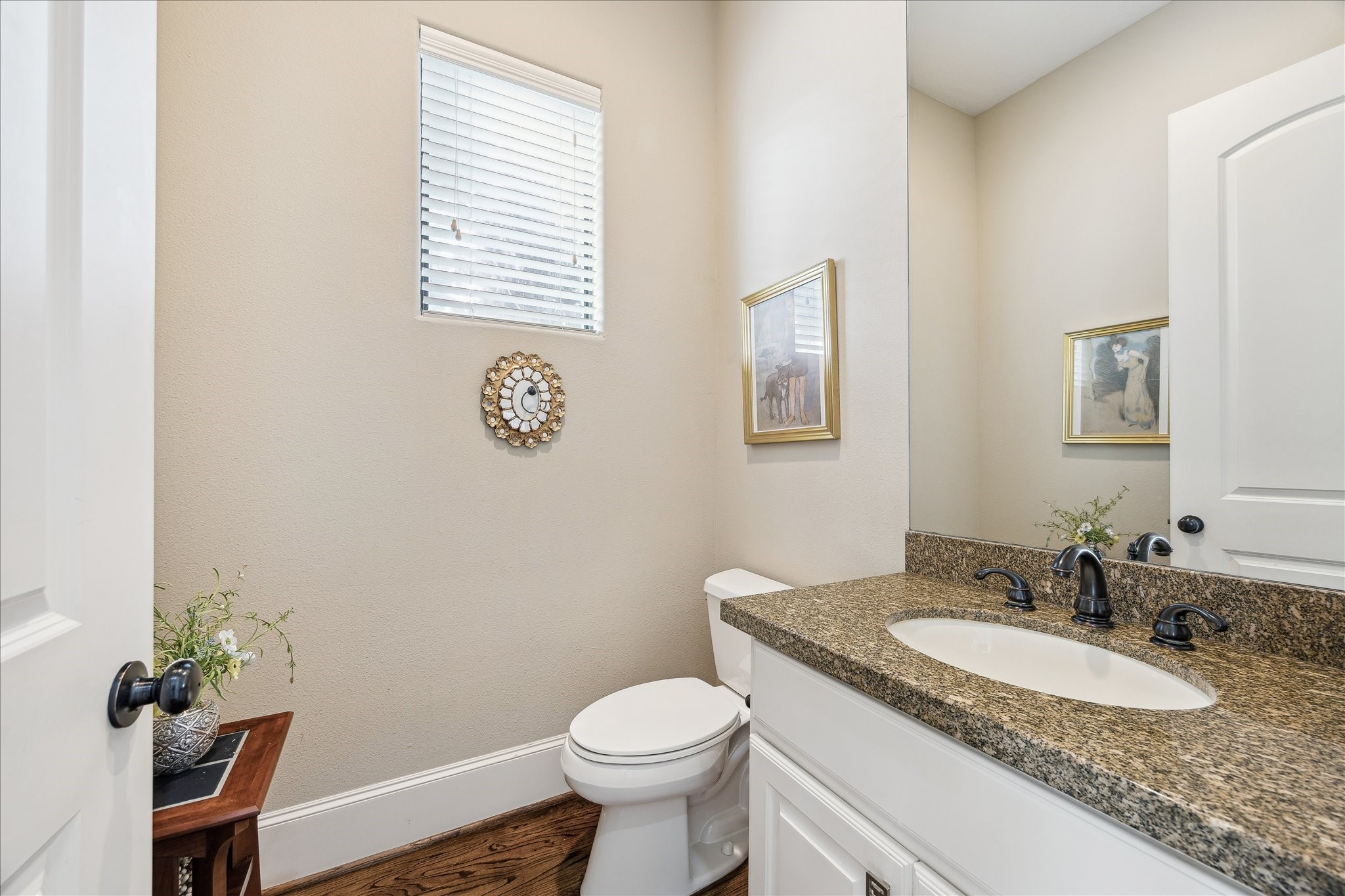 6311 Hamman Street, Unit A Houston, TX 77007 - Photo 20 of 30 a bathroom with a granite countertop sink toilet and a mirror