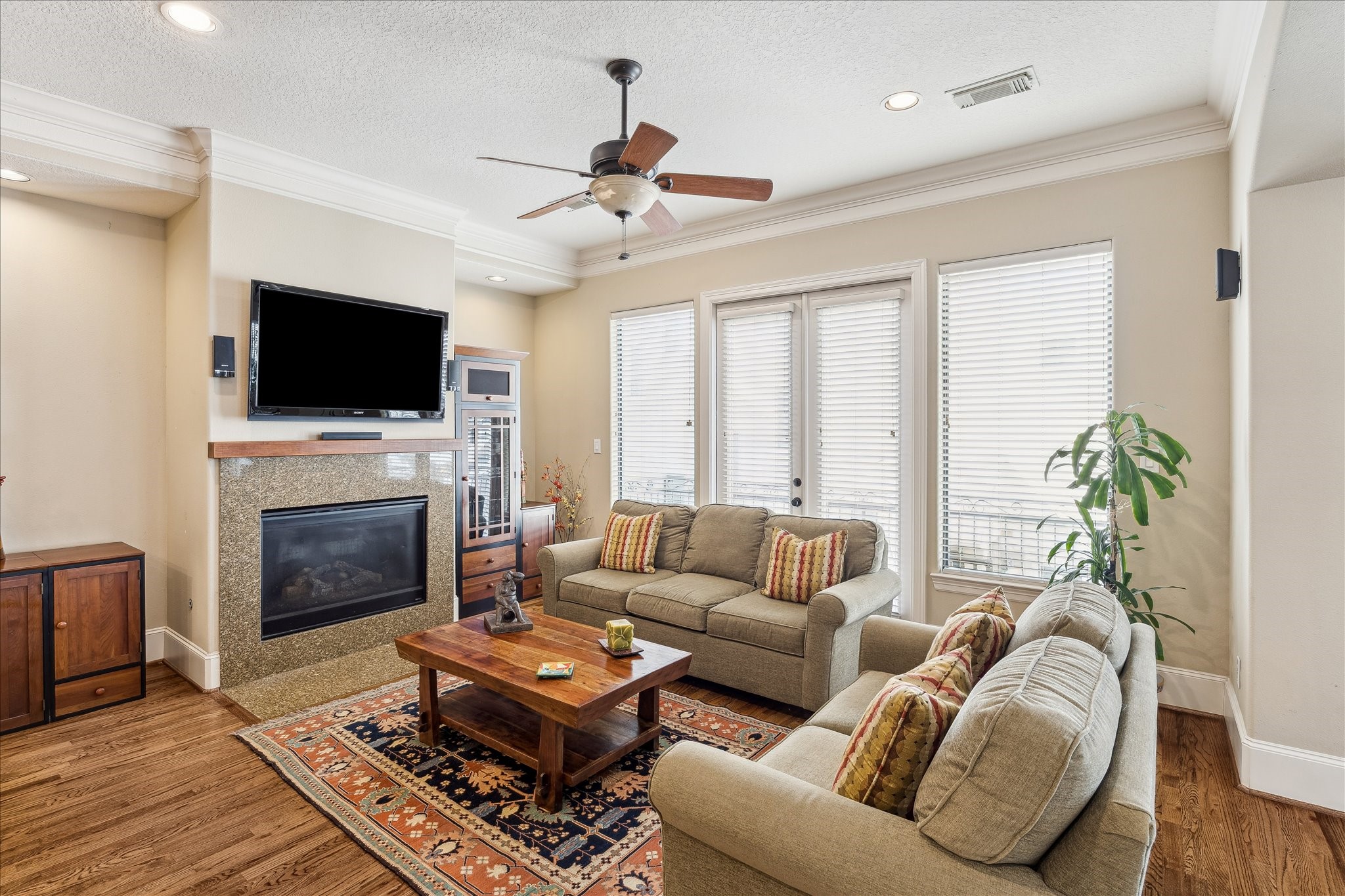 6311 Hamman Street, Unit A Houston, TX 77007 - Photo 10 of 30 a living room with furniture a fireplace and a flat screen tv