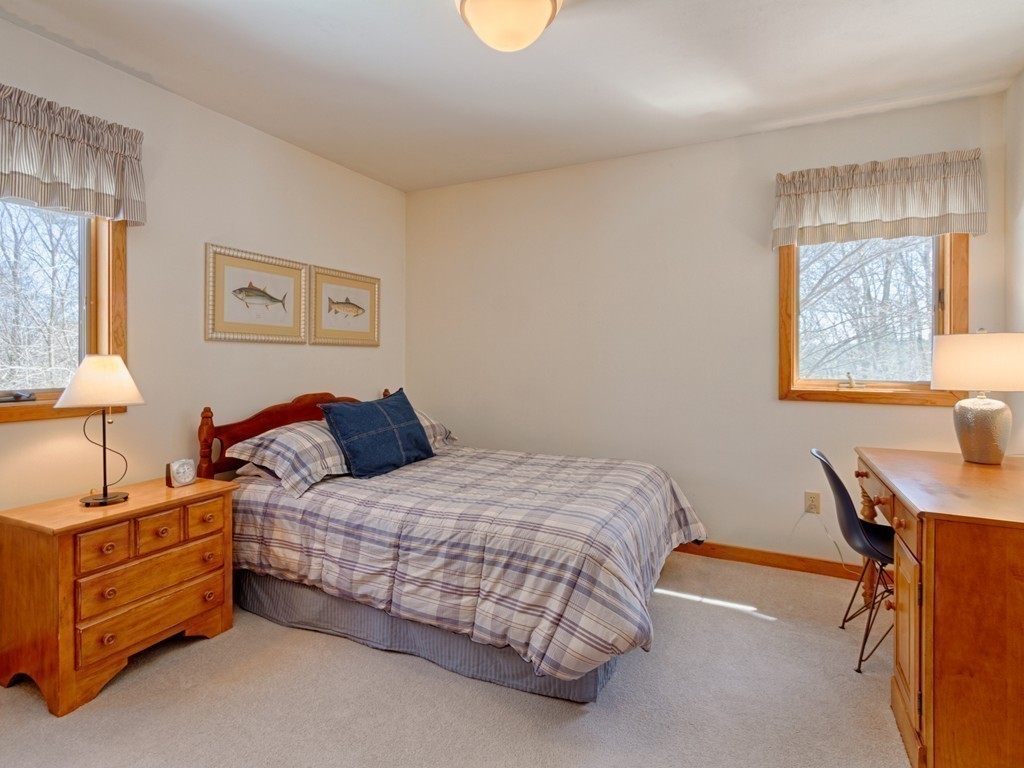 14 Skunk Road Merrimac, MA 01860 - Photo 17 of 25 a bedroom with a bed and a lamp on table
