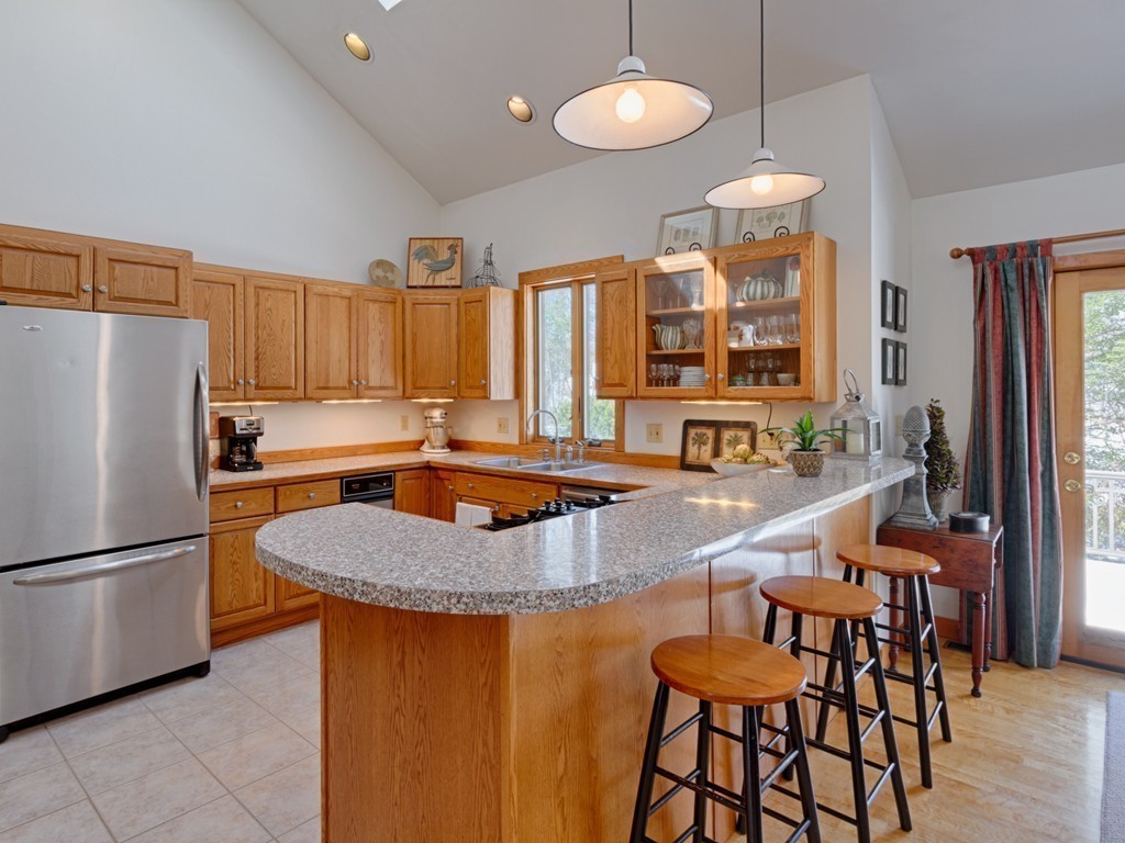14 Skunk Road Merrimac, MA 01860 - Photo 8 of 25 a kitchen with granite countertop a sink a center island a refrigerator and a center island