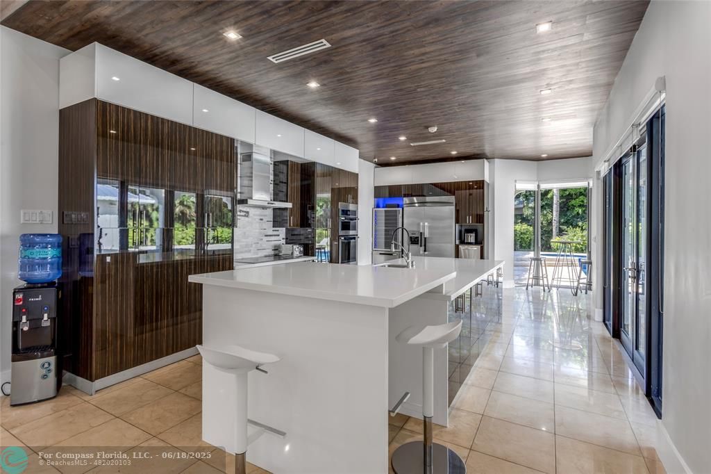 6901 Holatee Trail Southwest Ranches, FL 33330 - Photo 13 of 45 a kitchen with stainless steel appliances kitchen island granite countertop a refrigerator a sink a stove and a refrigerator