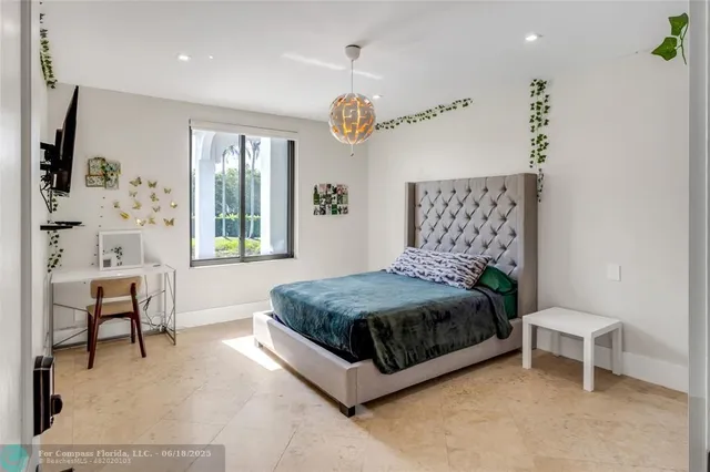 a bedroom with a bed and a table in it with window