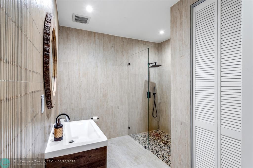 6901 Holatee Trail Southwest Ranches, FL 33330 - Photo 26 of 45 a bathroom with a sink and a mirror