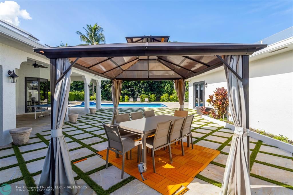 6901 Holatee Trail Southwest Ranches, FL 33330 - Photo 30 of 45 a patio with glass top table and chairs