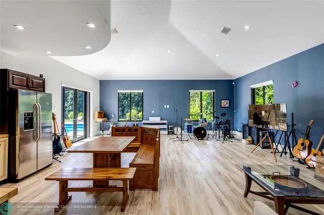 a living room with furniture a flat screen tv and a large window