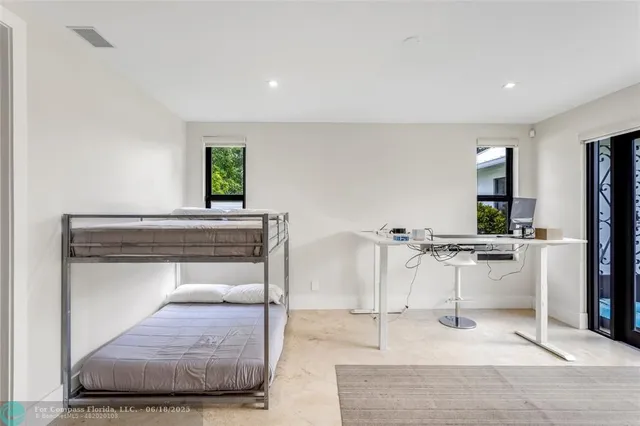a living room with furniture and view of kitchen appliances