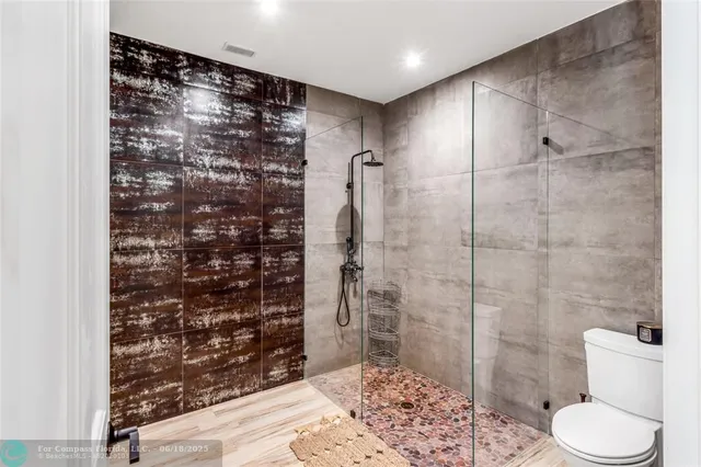 a bathroom with a shower and a toilet