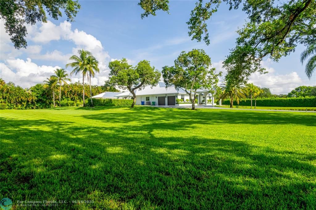 6901 Holatee Trail Southwest Ranches, FL 33330 - Photo 4 of 45 a front view of a house with garden