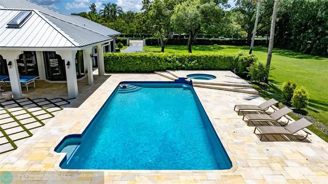 a view of swimming pool with a lounge chair