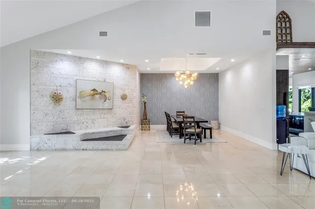 a lobby with furniture and a potted plant