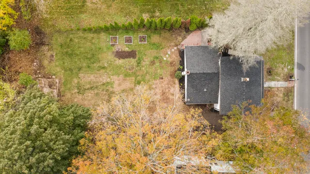 an aerial view of residential houses with trees