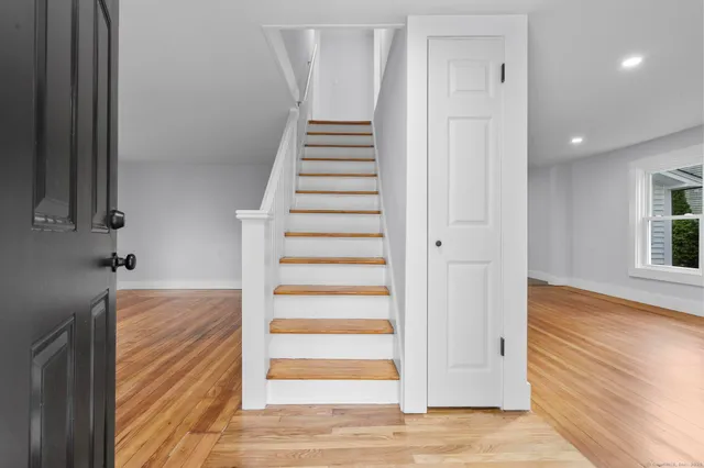 a view of an entryway with wooden floor