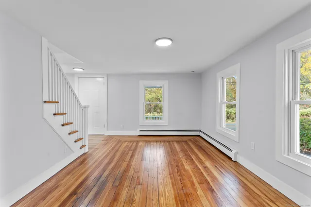 wooden floor in an empty room with a window