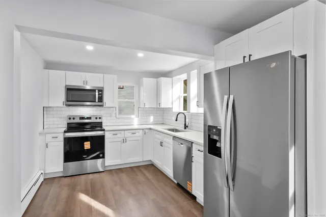 a kitchen with a sink stainless steel appliances and cabinets