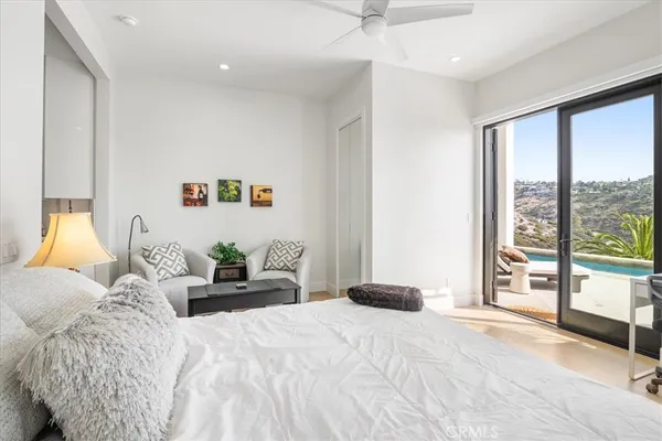 a bedroom with furniture and a potted plant