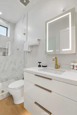 a kitchen with stainless steel appliances granite countertop a sink a stove top oven and cabinets
