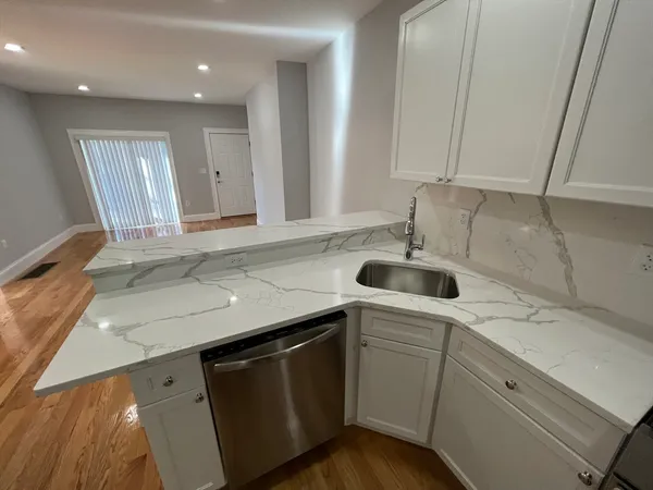 a kitchen with a sink cabinets and window