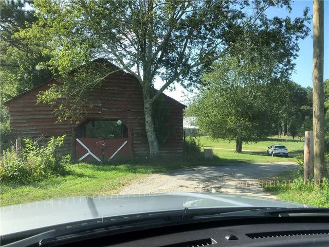 a view of a backyard with large trees