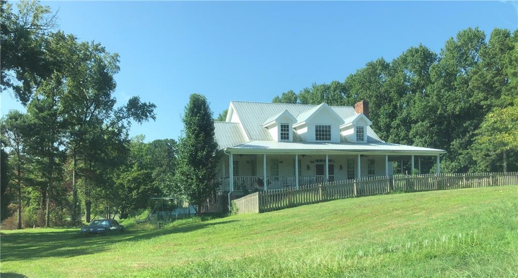 1405 Rock Springs Road Buford, GA 30519 - Photo 18 of 45 a view of a house with a large window and a yard