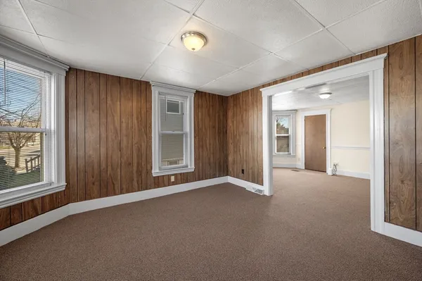 an empty room with windows and closet