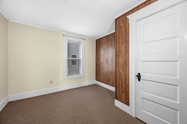 a view of an empty room with closet