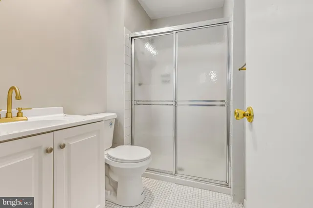 a bathroom with a shower toilet and sink