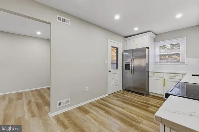 a view of a kitchen with wooden floor