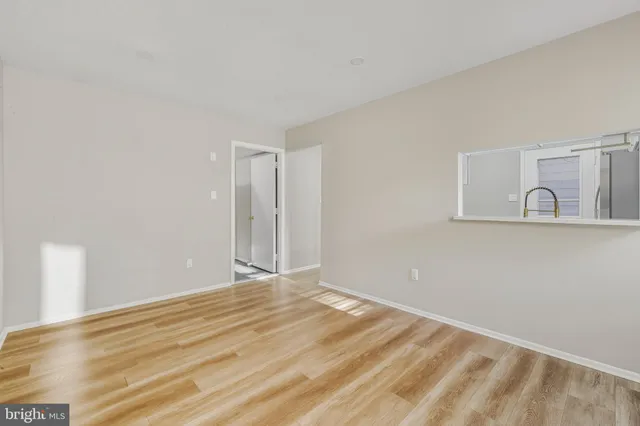 a view of a room with wooden floor