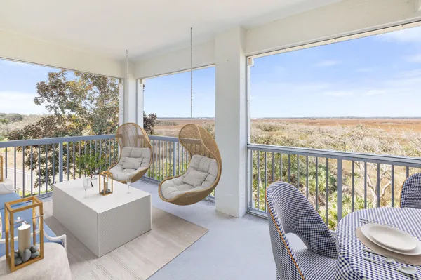 a living room with furniture a fireplace and a floor to ceiling window