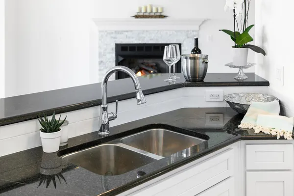 a kitchen with white cabinets and a sink