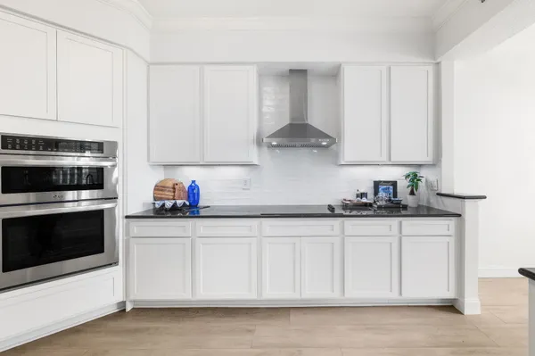 a kitchen with stainless steel appliances granite countertop a sink stove and cabinets