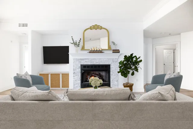 a living room with furniture and a fireplace