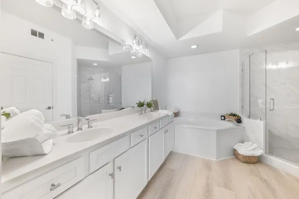 a bathroom with a sink mirror toilet and shower