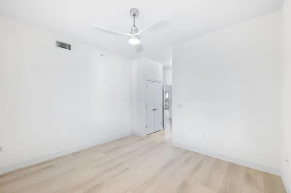a view of empty room with floor to ceiling window and an empty room