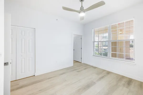 a view of a balcony with wooden floor and fence
