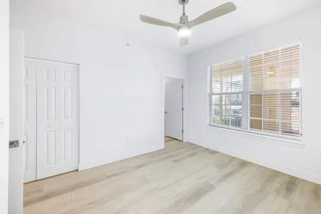 a view of a balcony with wooden floor and fence