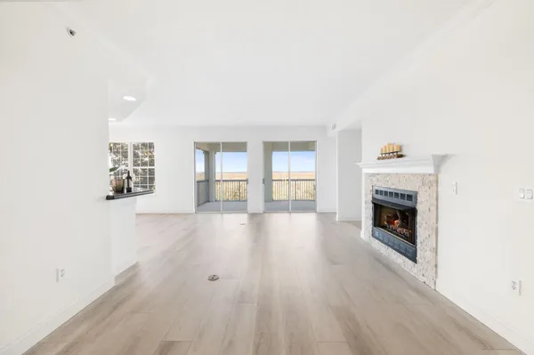 a living room with a fireplace and a wooden floor