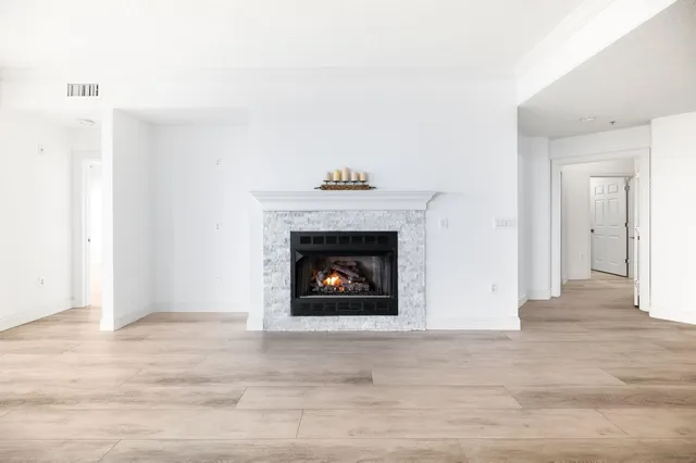 a view of a livingroom with a fireplace a fireplace and window