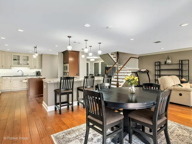 a dining room with furniture and wooden floor