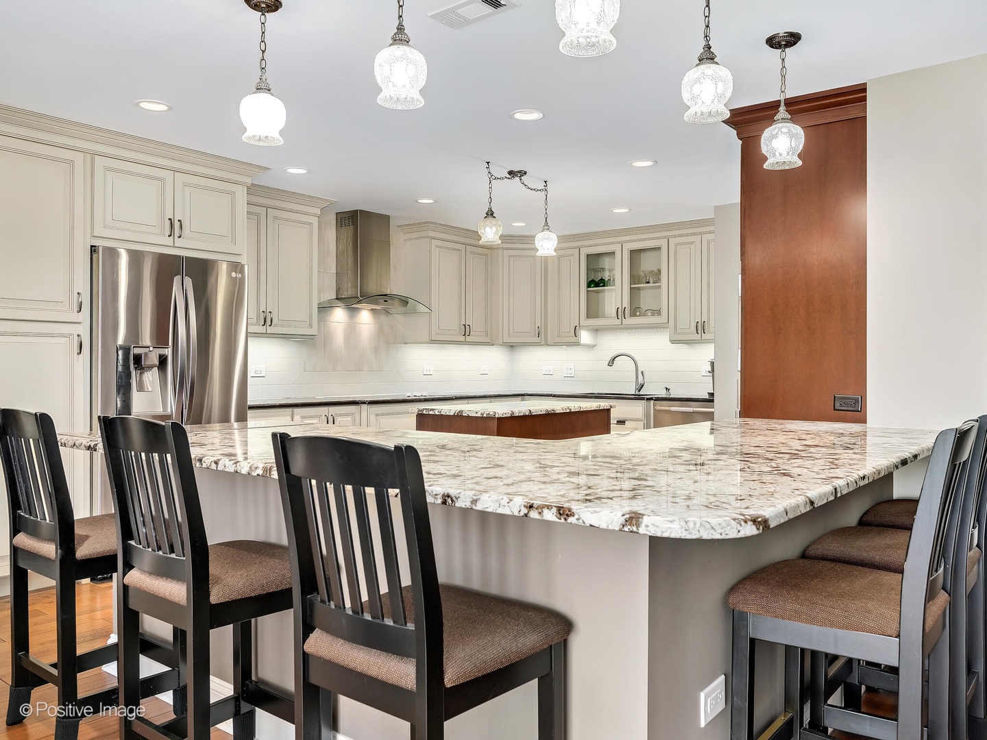 1401 Burr Oak Road, Unit 114B Hinsdale, IL 60521 - Photo 14 of 40 a kitchen with kitchen island granite countertop a table chairs stove microwave and refrigerator