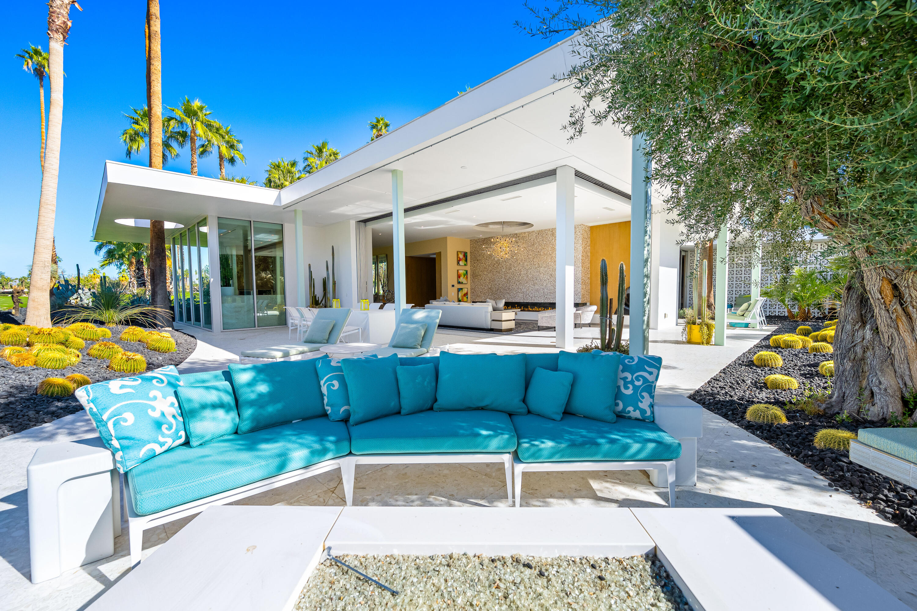 40365 Sand Dune Road Rancho Mirage, CA 92270 - Photo 23 of 70 a view of a patio with couches table and chairs with wooden floor and fence