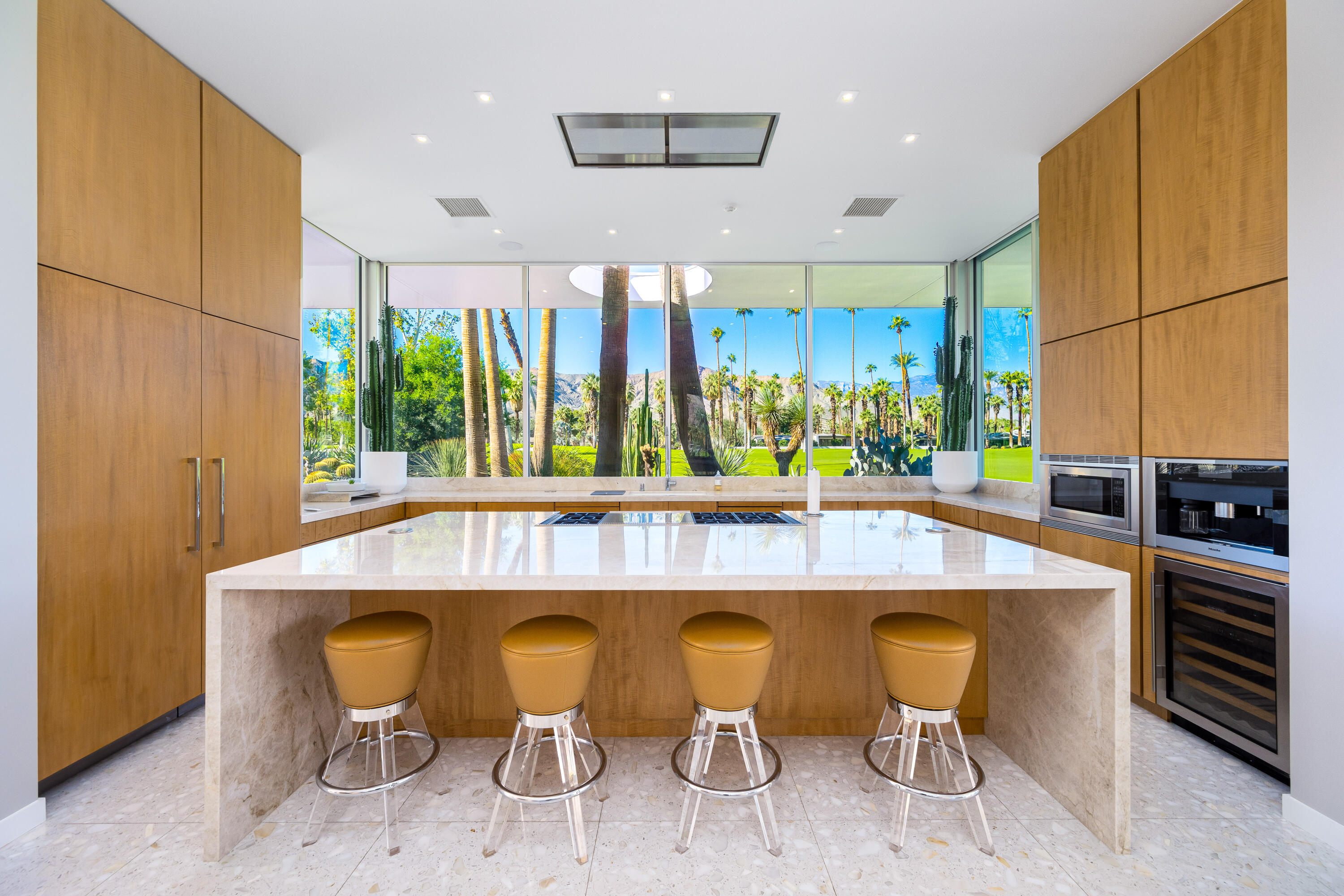 40365 Sand Dune Road Rancho Mirage, CA 92270 - Photo 29 of 70 a kitchen with a table chairs refrigerator and microwave