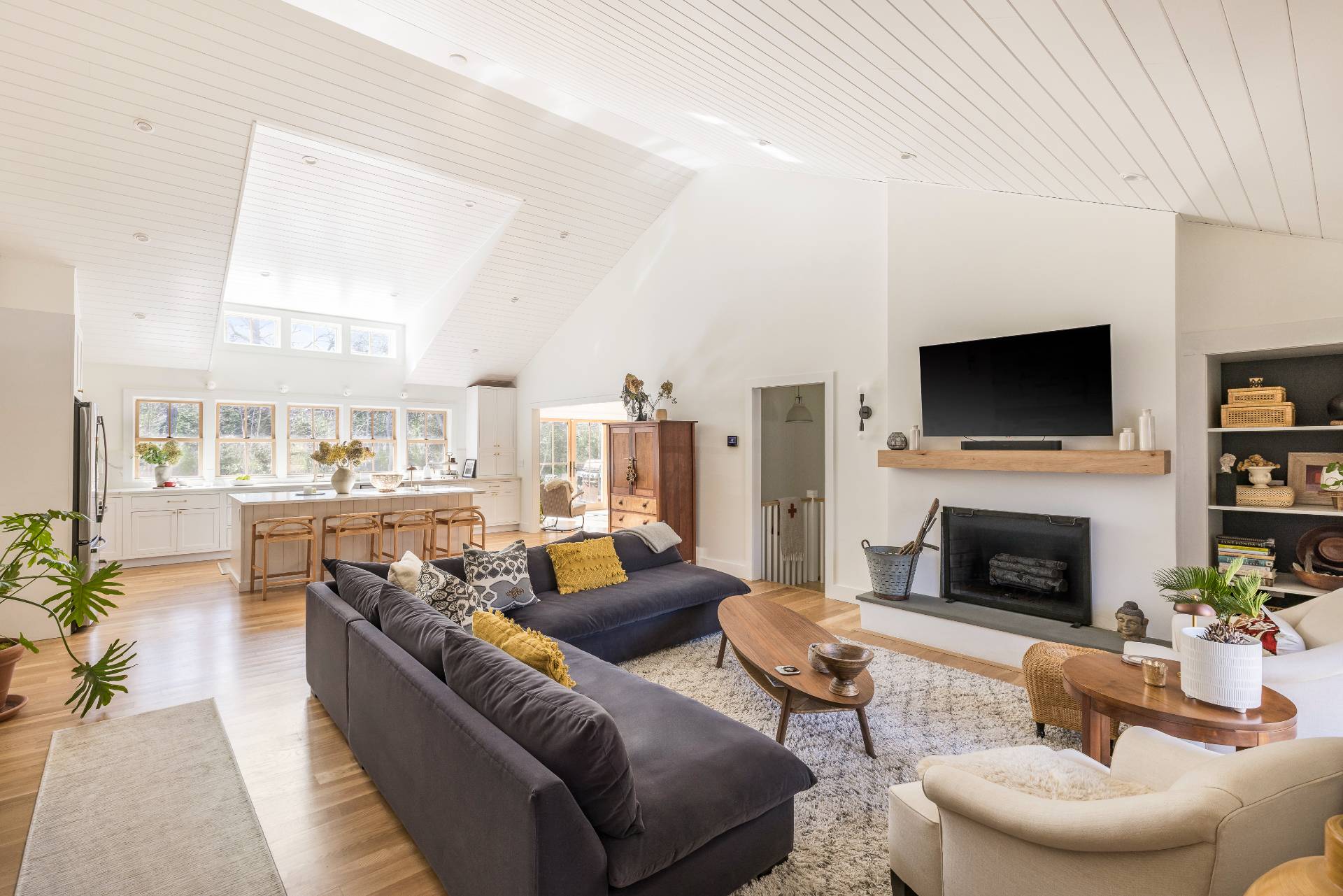 a living room with furniture a fireplace and a flat screen tv