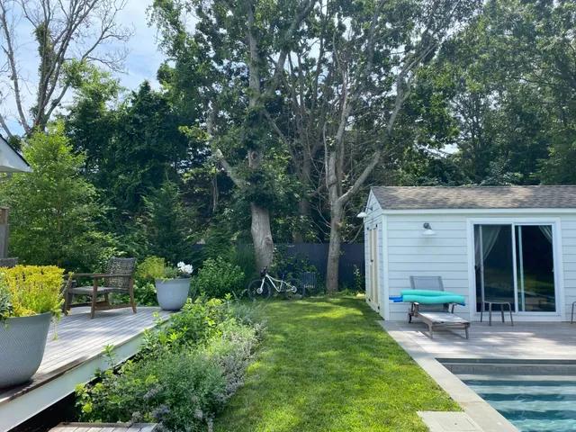a front view of a house with garden and porch