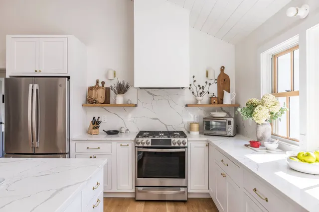 a kitchen with stainless steel appliances a stove and cabinets