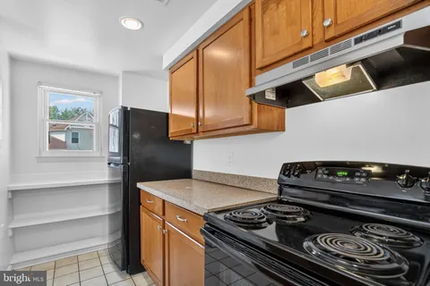 a kitchen with stainless steel appliances granite countertop a stove and a refrigerator