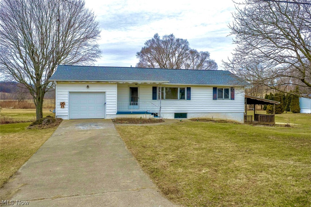 3336 Broad Run Dairy Road Northwest Dover, OH 44622 - Photo 1 of 26 Ranch-style home featuring an attached garage, driveway, and a front yard