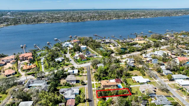 an aerial view of a houses with a lake