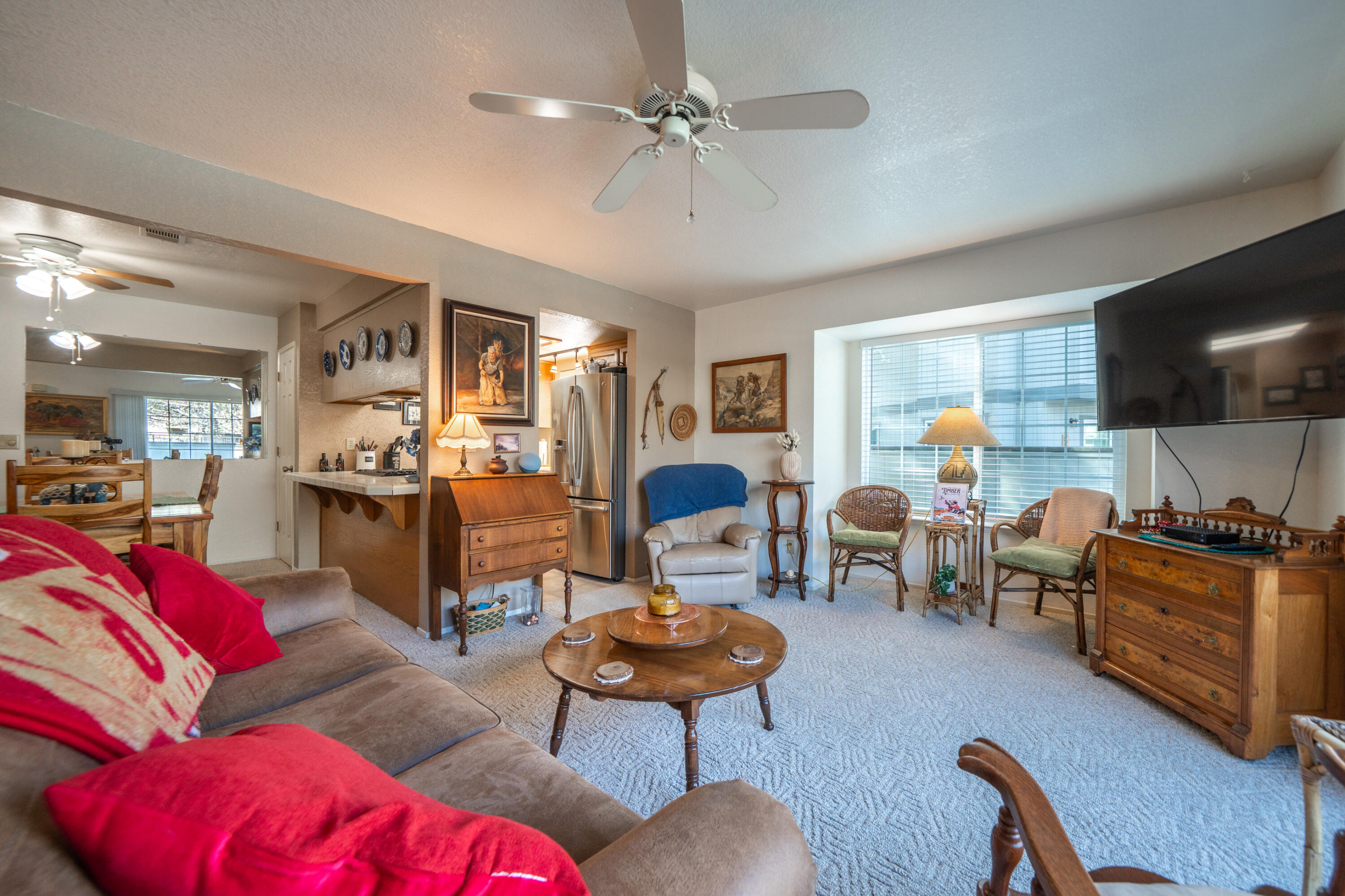 200 Ridgetop Drive, Unit 19 Redding, CA 96003 - Photo 11 of 53 a living room with furniture a flat screen tv and kitchen view